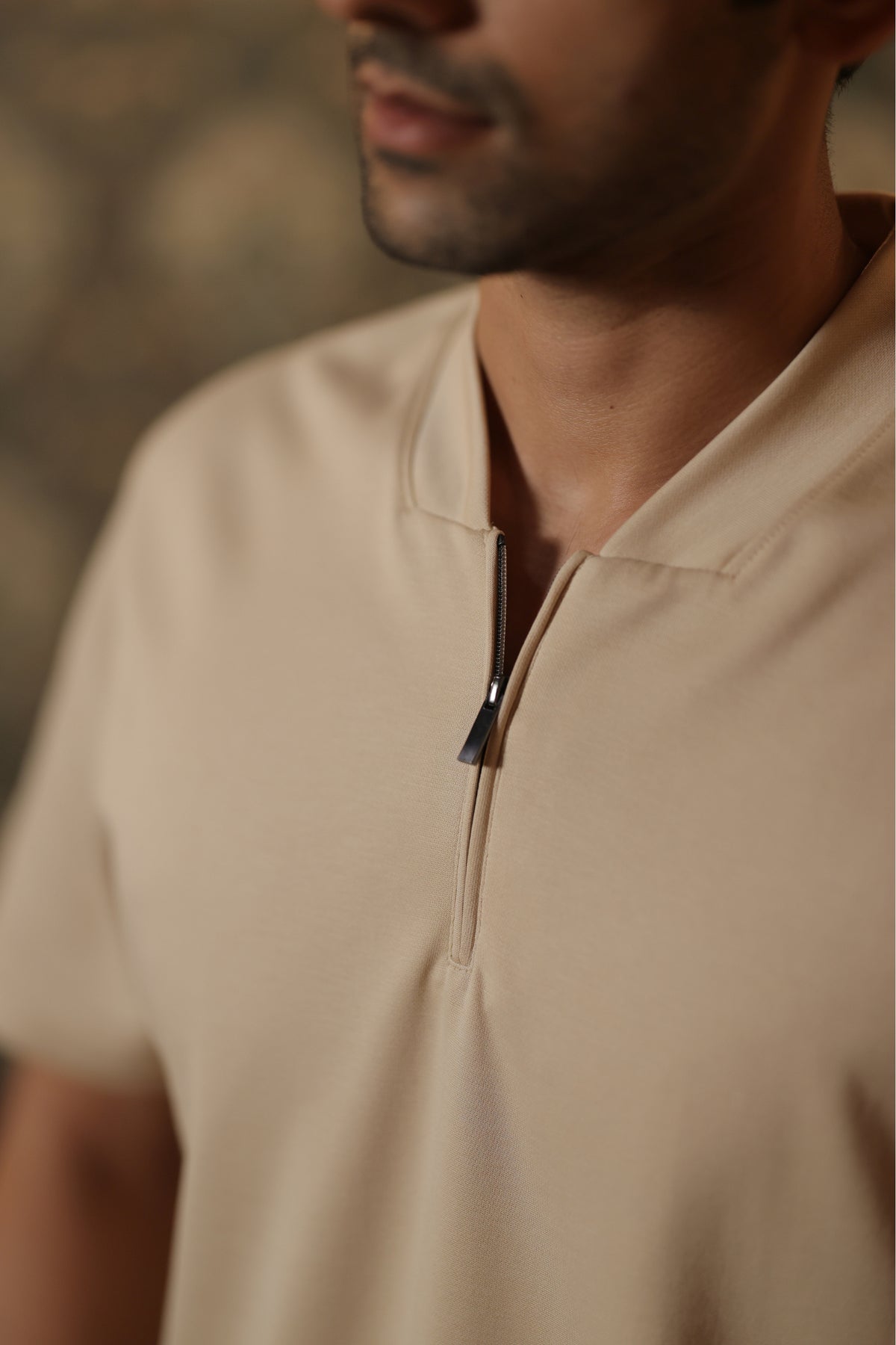 Ivory quarter-zip collar detail