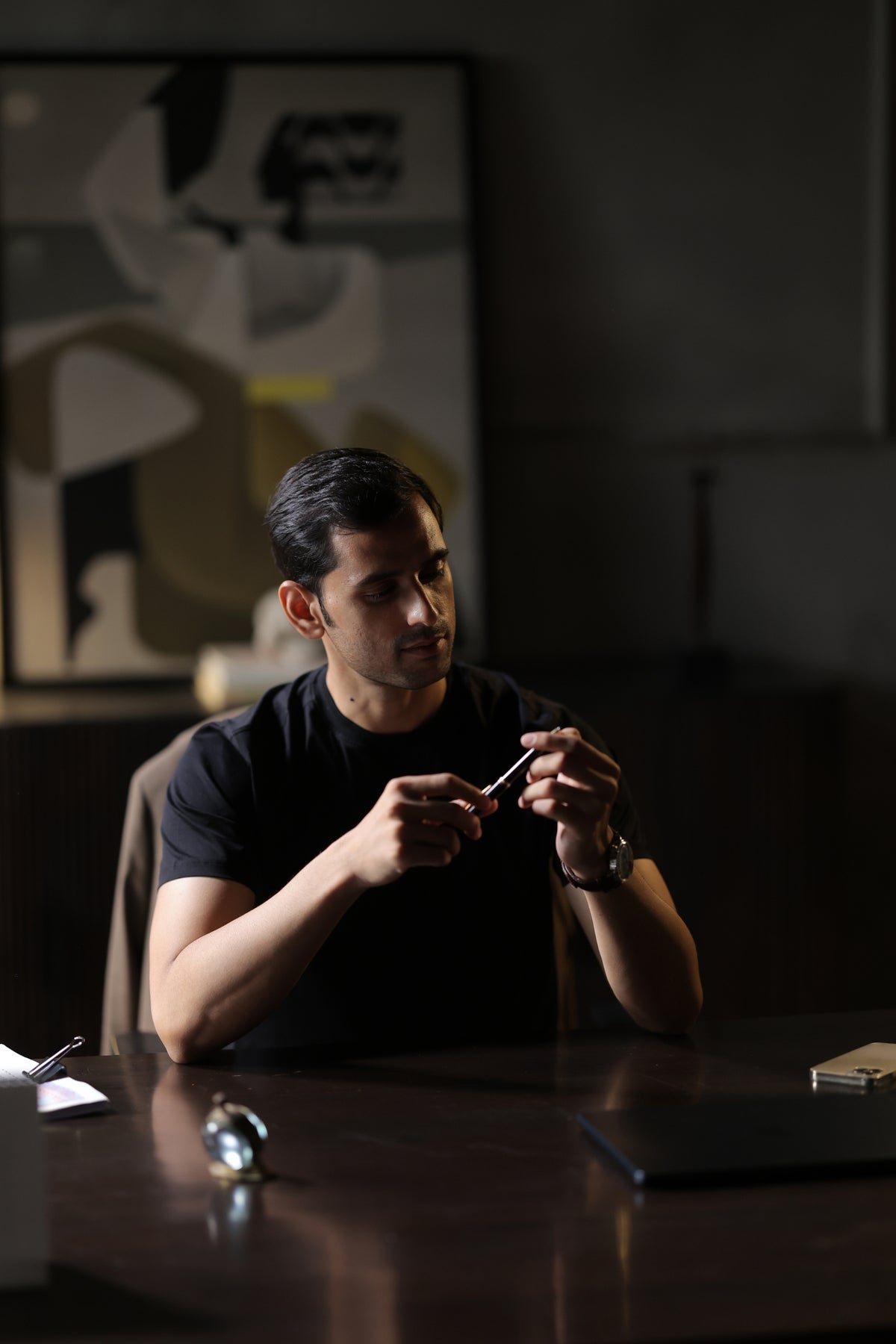 Man in a black T-shirt holding a camera