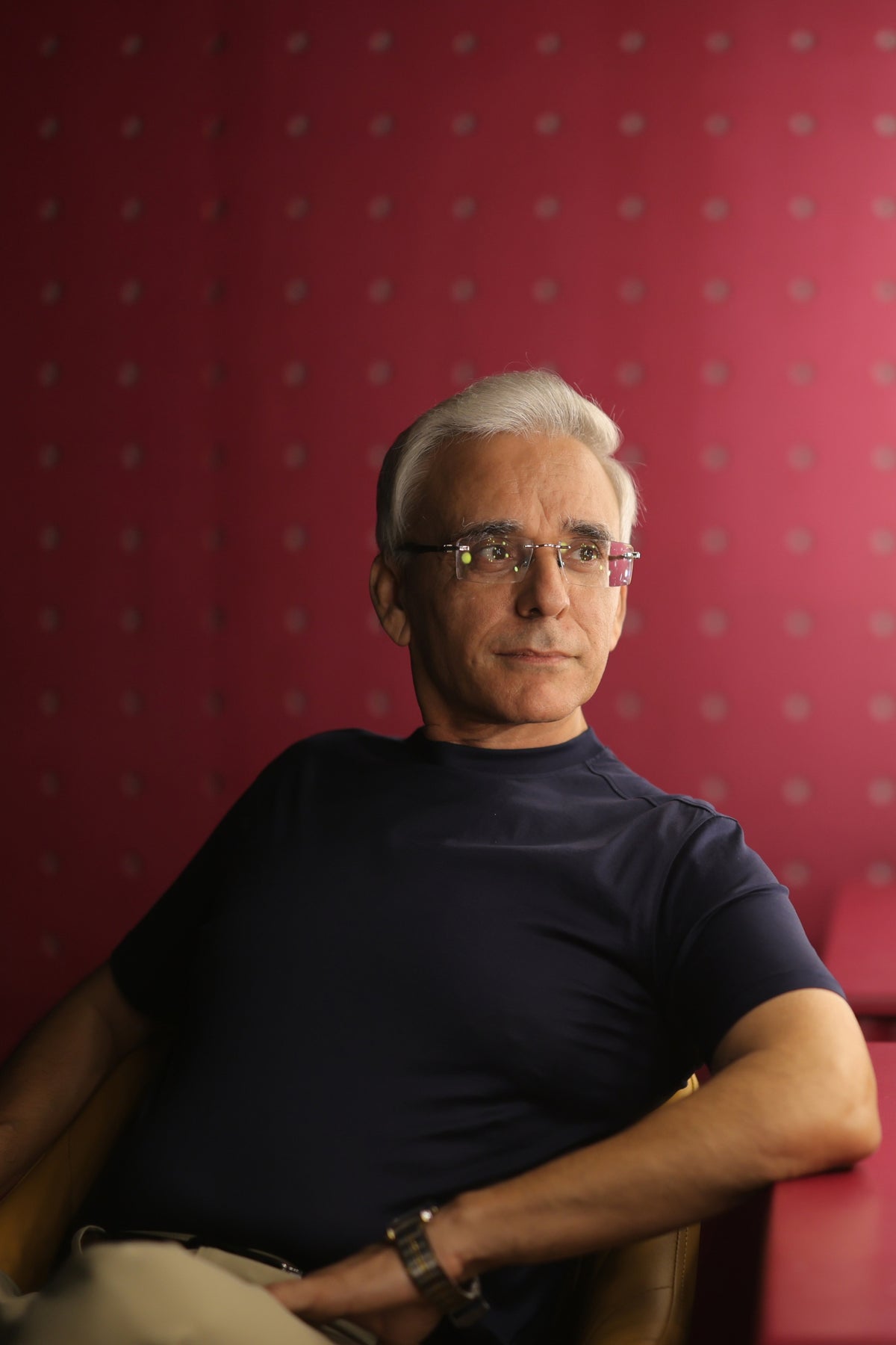 Man seated in a navy T-shirt