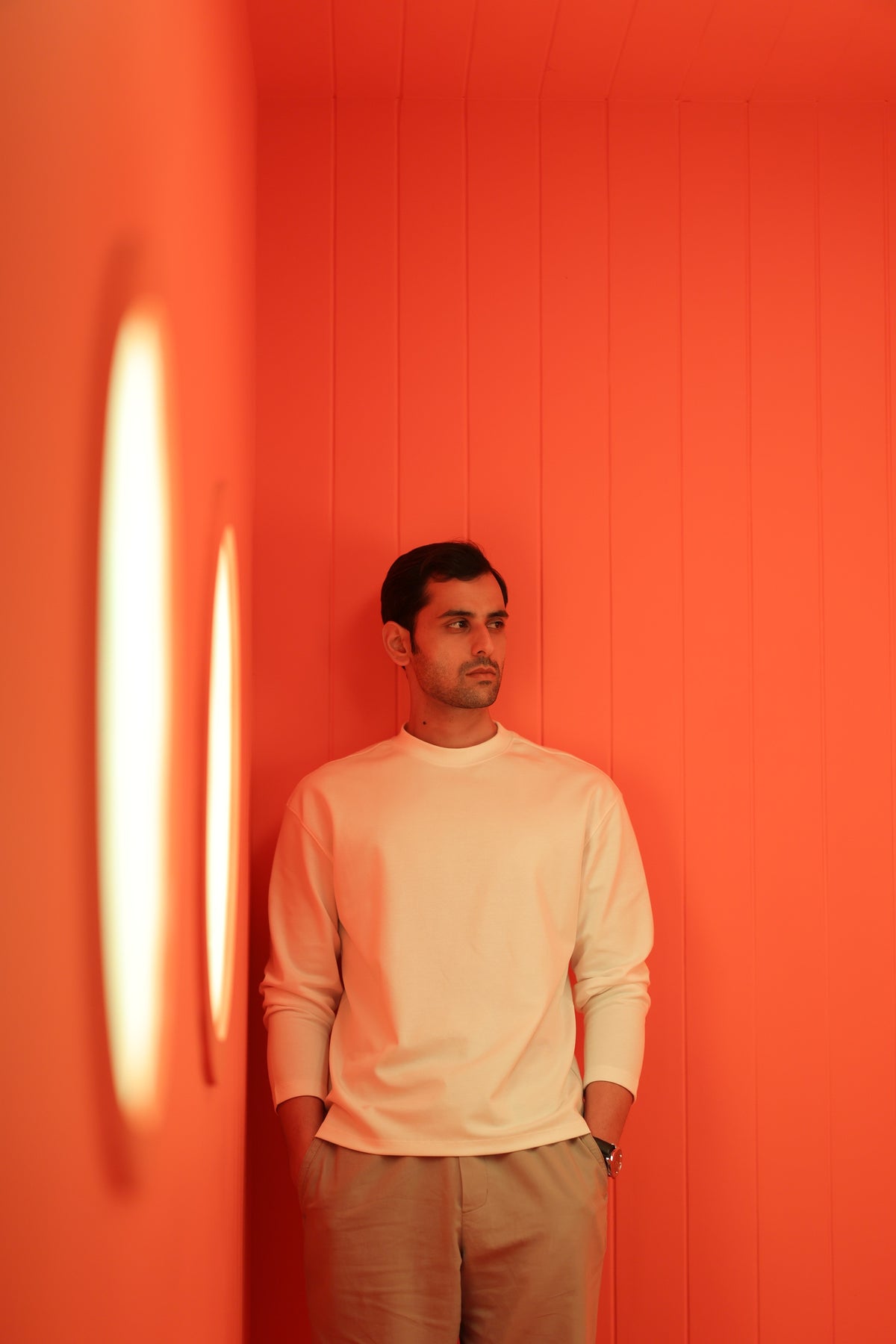 Man wearing ivory in an orange room